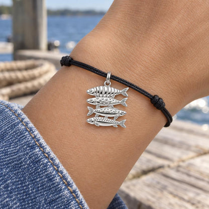 School of Four Fish Charm Bracelet – Personalized Mom Gift – worn on the wrist on a black cord bracelet