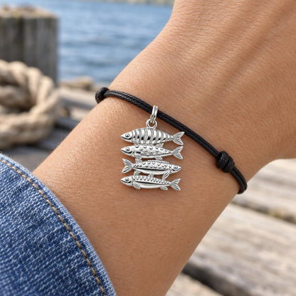 School of Four Fish Charm Bracelet – Personalized Mom Gift – worn on the wrist on a black cord bracelet