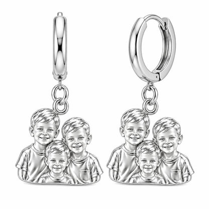 Sculpted Children Portrait Huggie Charm Earrings – silver, front view
