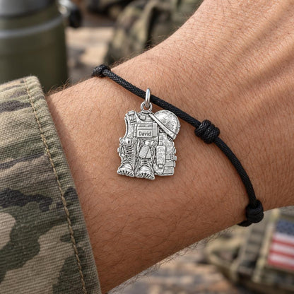Soldier's Gear Tribute Charm Bracelet – Personalized Veteran Gift – worn on the wrist on a black cord bracelet