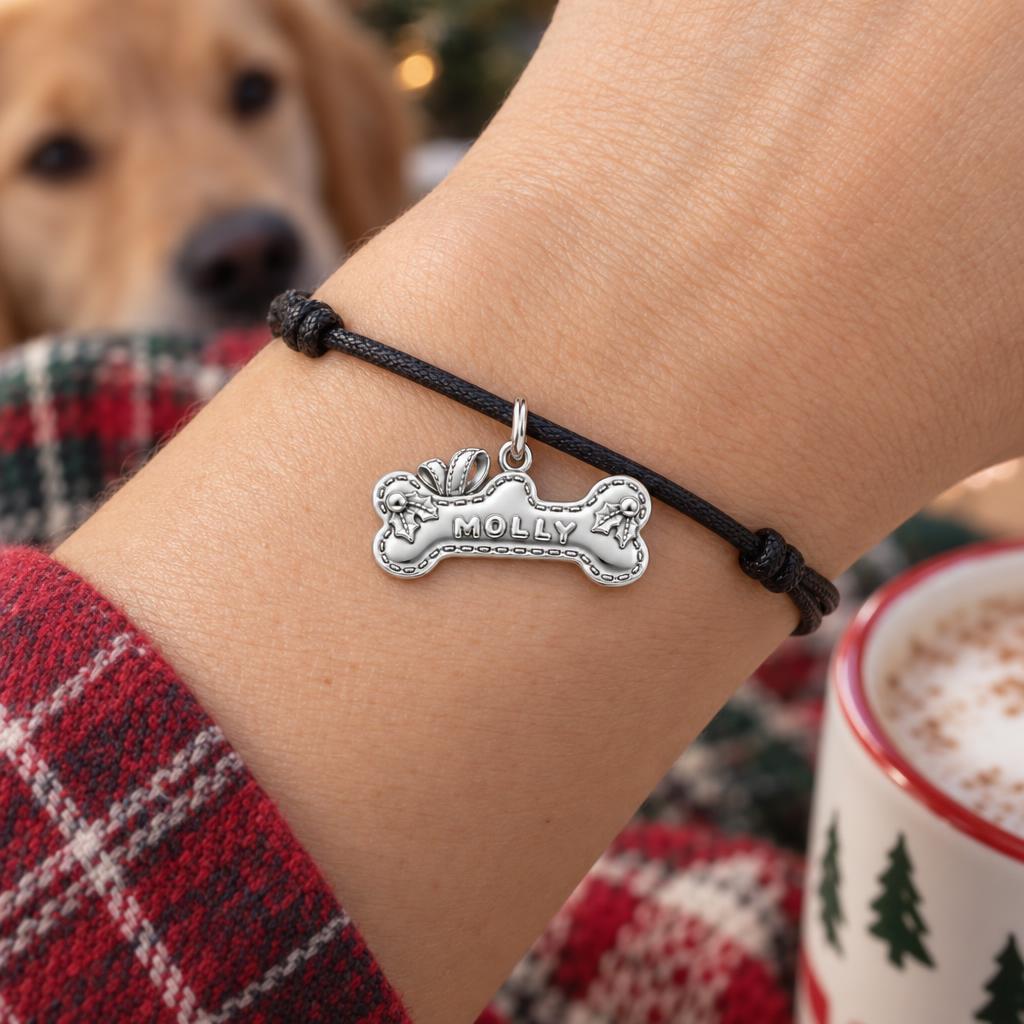 Stitched Holiday Bone Charm Bracelet – Personalized Dog Mom Gift – worn on the wrist on a black cord bracelet