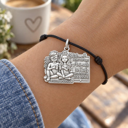 Welcome to the Zoo Charm Bracelet – Personalized Couple Gift – worn on the wrist on a black cord bracelet